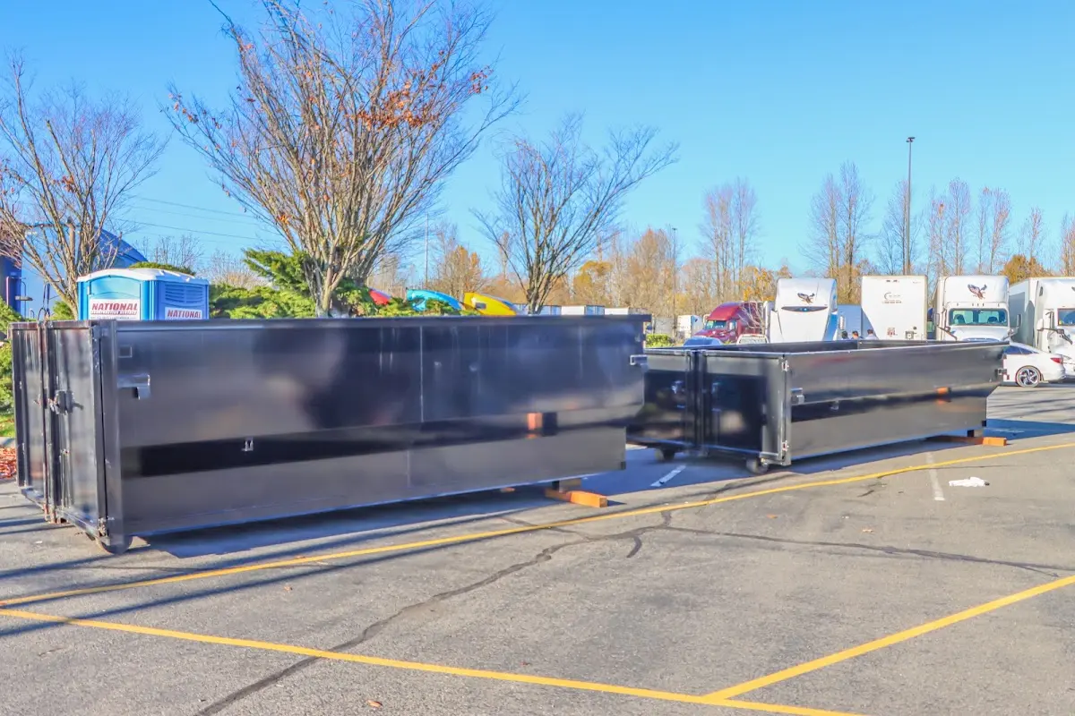 Professional dumpster rental service with roll-off container on residential driveway in North Huntingdon